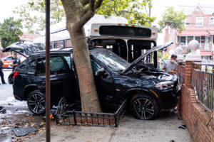 black SUV and MTA bus crashed into tree and fence near Queens, NY