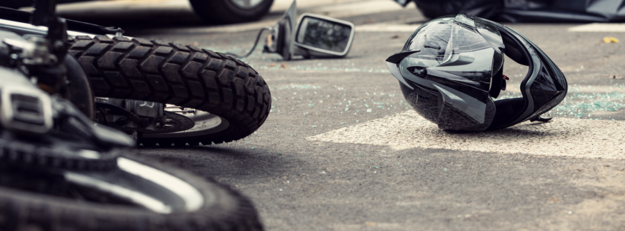 Motorcycle and helmet on the street after dangerous traffic incident