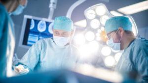 doctors surrounding a surgical amputation
