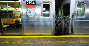 Subway car with passenger in NYC at station