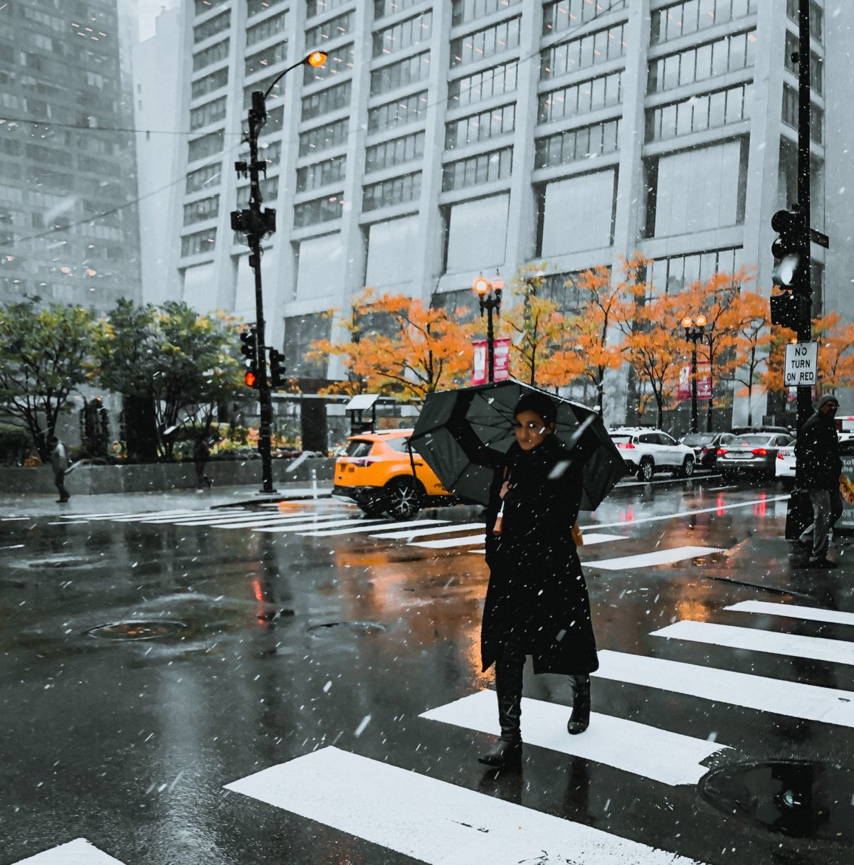 Woman walking as it starts to snow in NYC