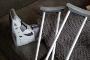 crutches and boot on someone who had a slip and fall injury in NY