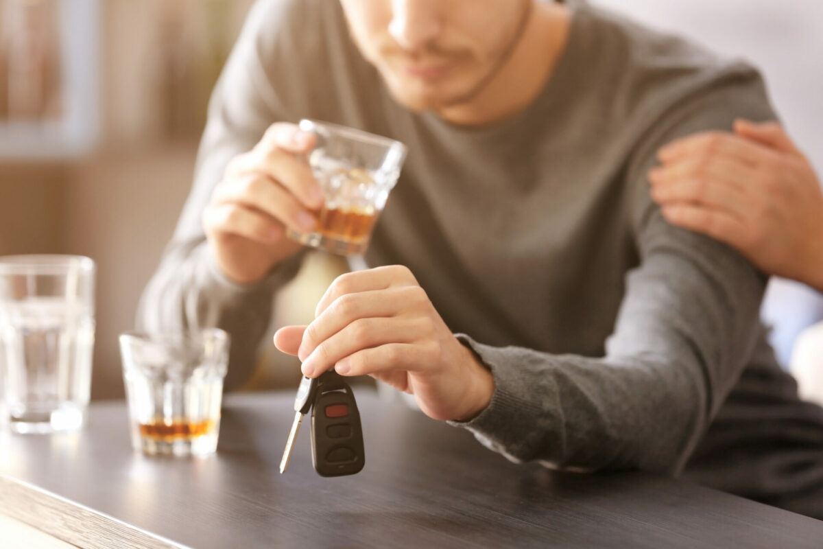 drunk man holding keys getting ready to drive under the influence