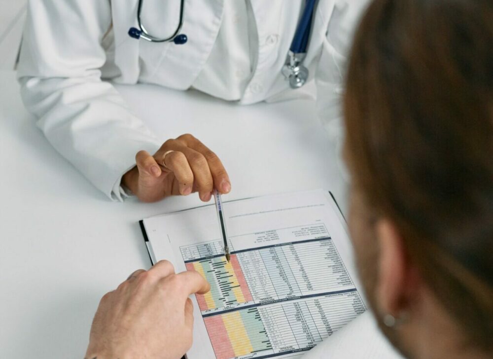 pediatrician reviewing medical charts for patient