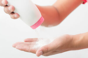 talcum powder as an ingredient in baby powder in someone's hands