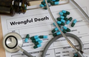 Stethoscope, pills and wrongful death document