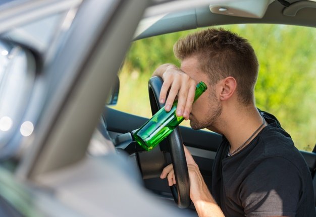 man holding a bottle, drunk driving