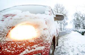 car covered in snow, driving in NY during a snowstorm