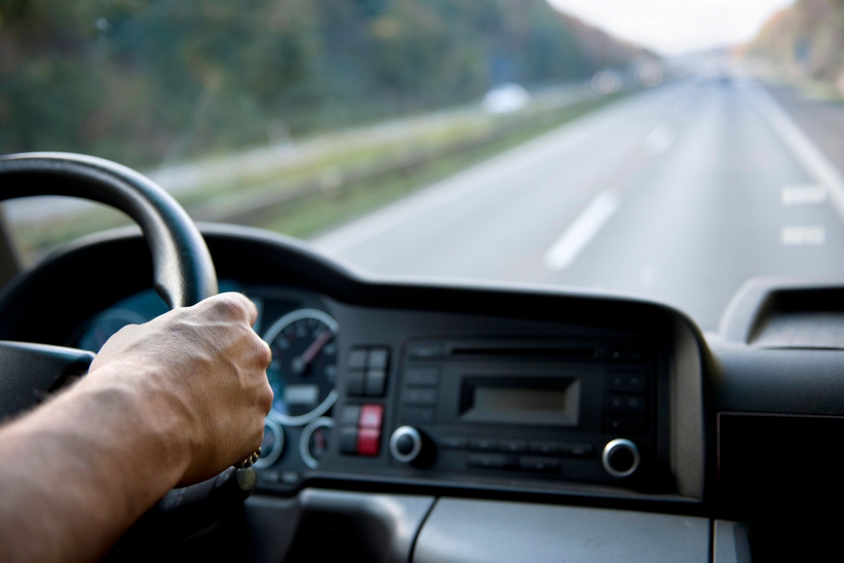 Person driving a truck on the road