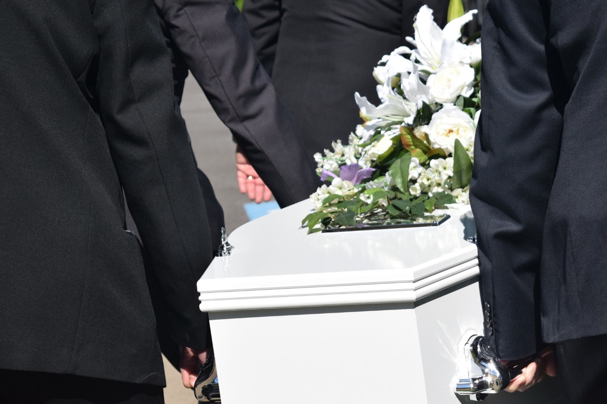 Deceased person being carried away in a coffin