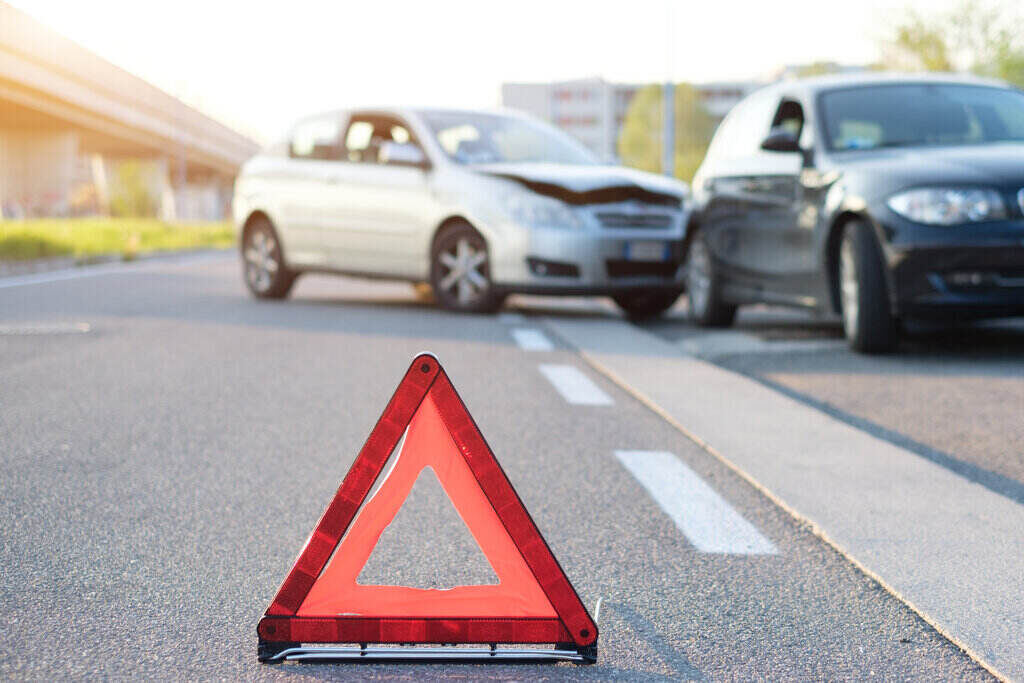 Scene of a car accident and warning triangle at the front