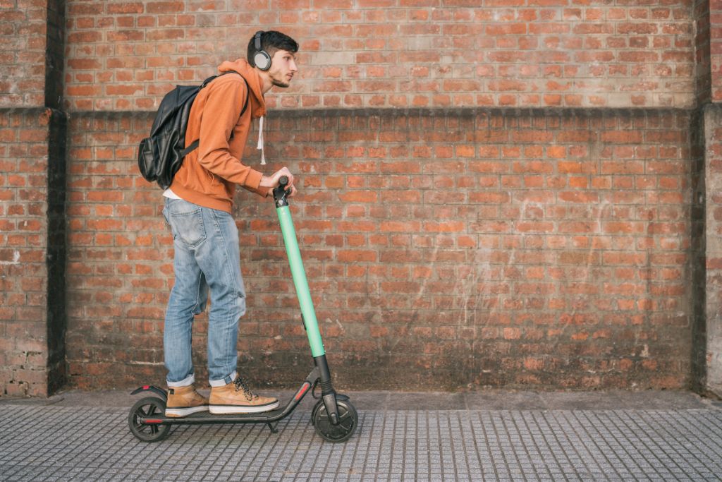 young man riding an electric scooter in Queens