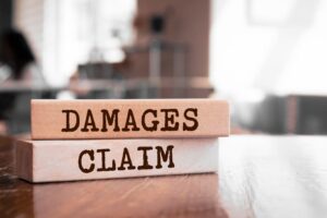Damages & Claim written on wood blocks