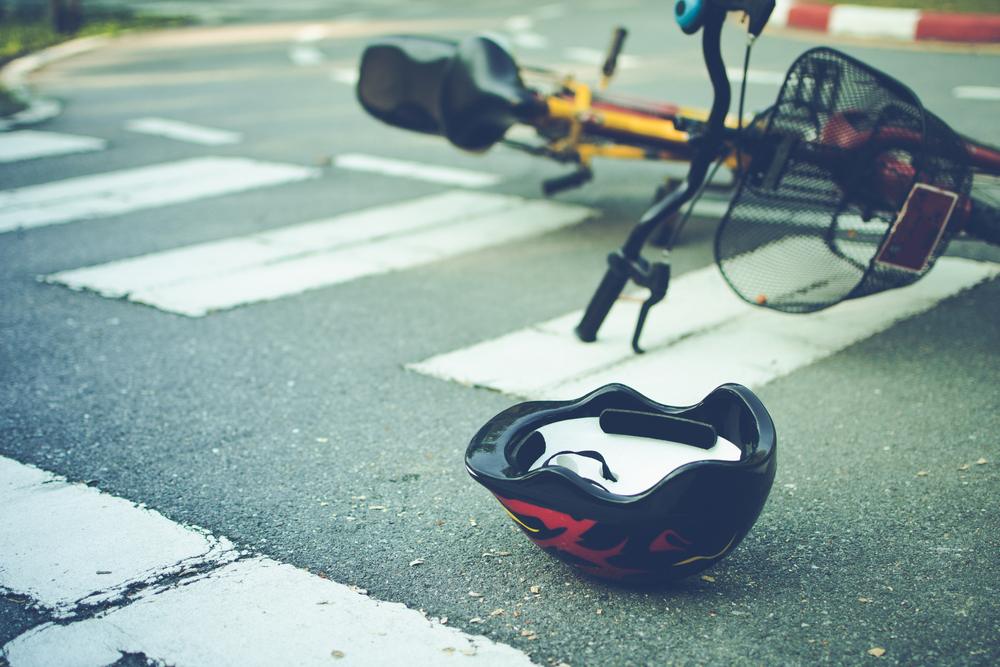 Bicycle and helmet on the road after a cyclist was hit in a crosswalk, illustrating a serious Brooklyn bicycle accident.