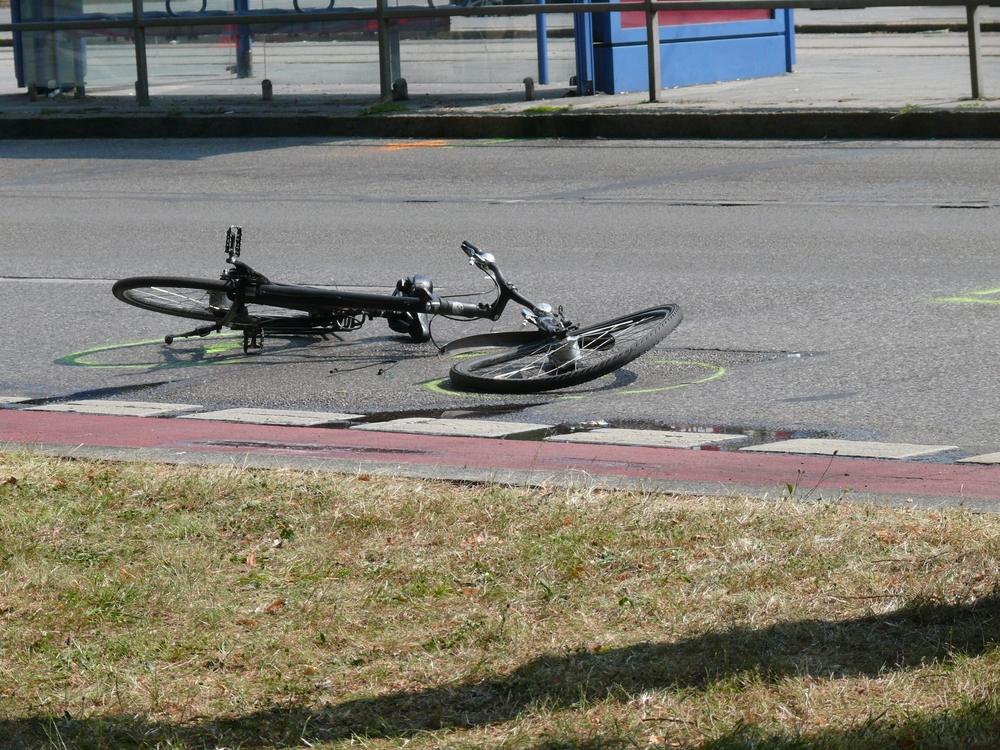 Damaged bicycle lying in the road after a Brooklyn bicycle accident, showing impact and evidence useful for injury claims.