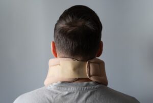 Person wearing a cervical collar for neck stabilization after serious spine injury