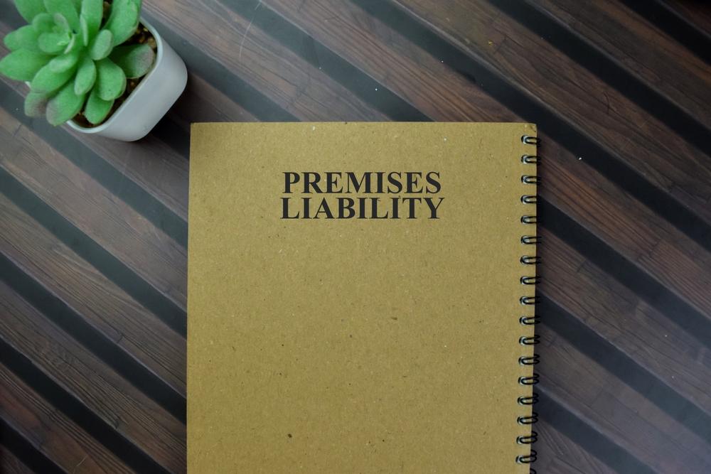 Notebook labeled Premises Liability on a desk, symbolizing unsafe property conditions and injury claims in Brooklyn