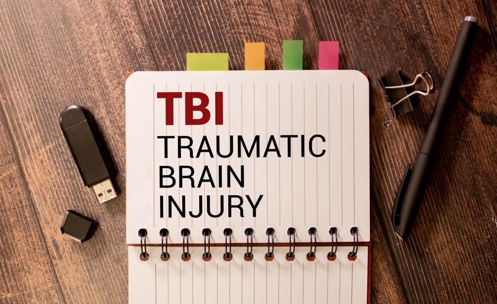 Notebook labeled TBI Traumatic Brain Injury used for medical and legal documentation