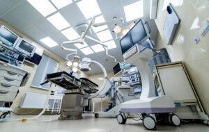 empty operating room equipped with surgical tables and medical equipment